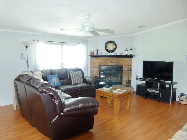 living room featuring a textured ceiling, wood finished floors, a ceiling fan, and crown molding