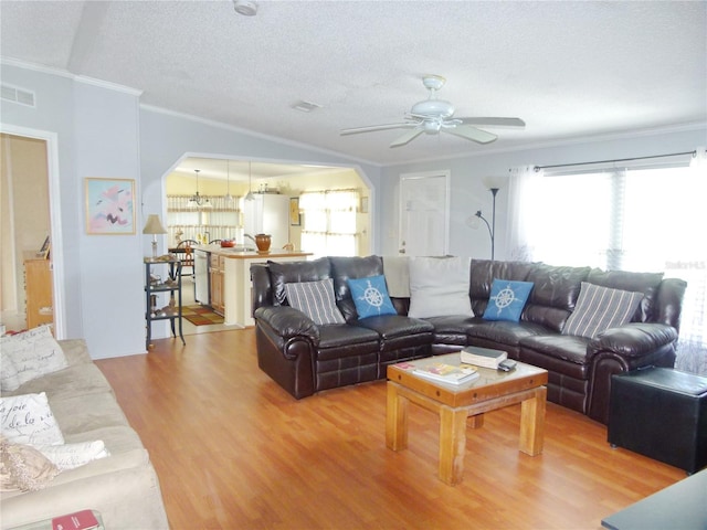 living room with visible vents, wood finished floors, crown molding, a textured ceiling, and ceiling fan with notable chandelier