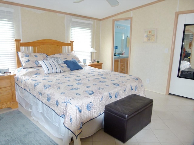 bedroom featuring light tile patterned floors, ceiling fan, crown molding, and ensuite bathroom