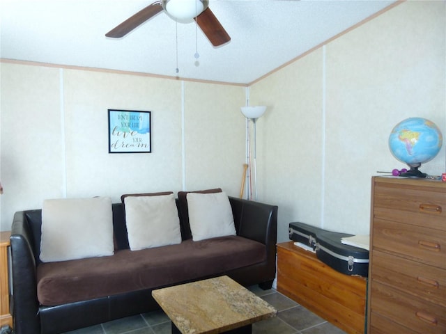 living area with ornamental molding, ceiling fan, and tile patterned floors