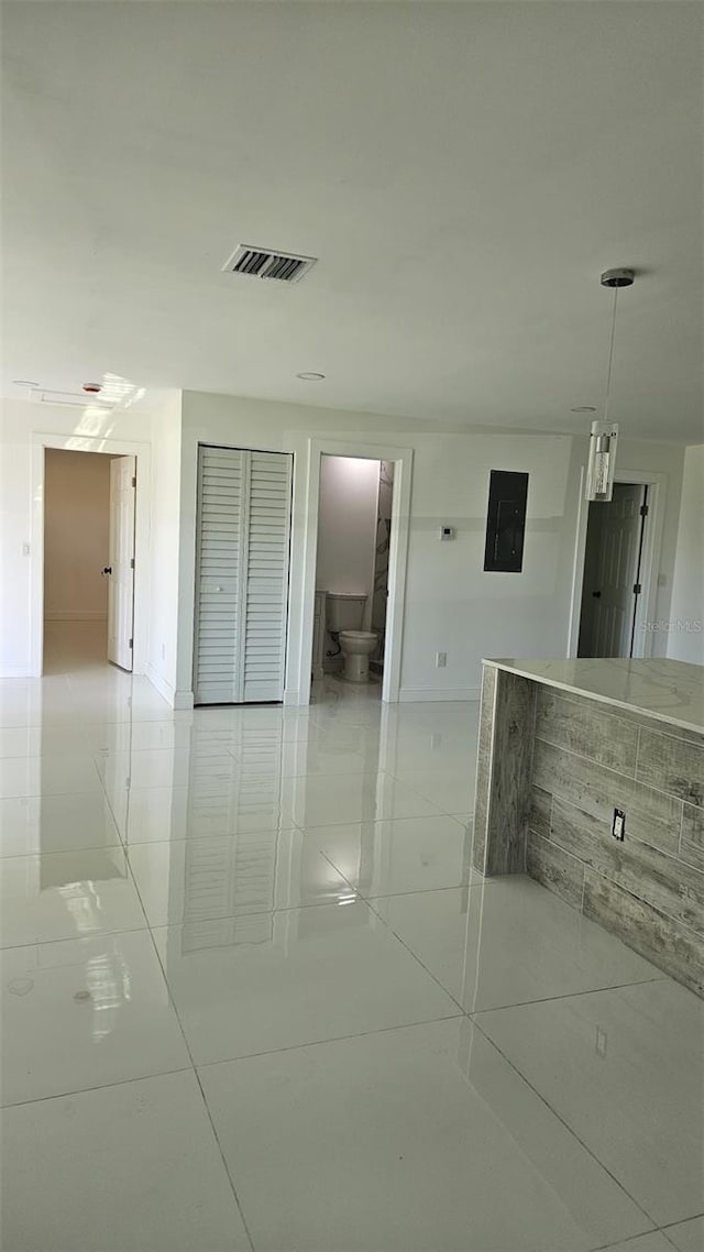 corridor featuring visible vents and electric panel