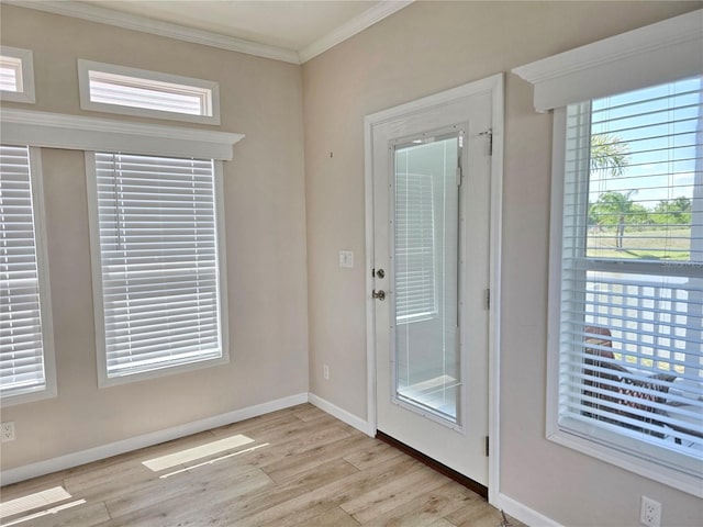 649 SW 34th Cv Unit 392, Okeechobee, FL 34974 - doorway to outside with light wood-style floors, ornamental molding, and healthy amount of natural light