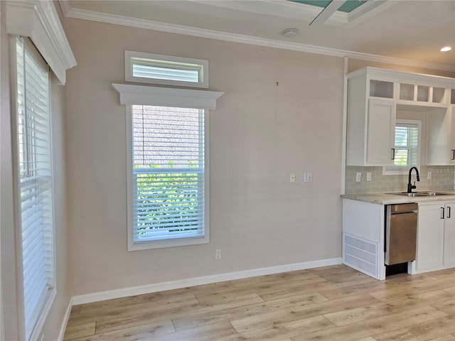 649 SW 34th Cv Unit 392, Okeechobee, FL 34974 - kitchen with crown molding, dishwasher, white cabinets, light wood finished floors, and backsplash