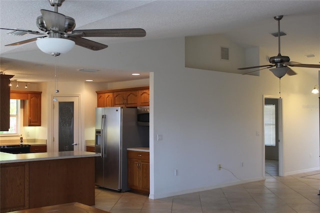 kitchen featuring visible vents, ceiling fan, light tile patterned flooring, and stainless steel fridge with ice dispenser