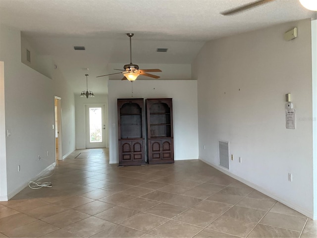 interior space with visible vents, ceiling fan, light tile patterned floors, and lofted ceiling