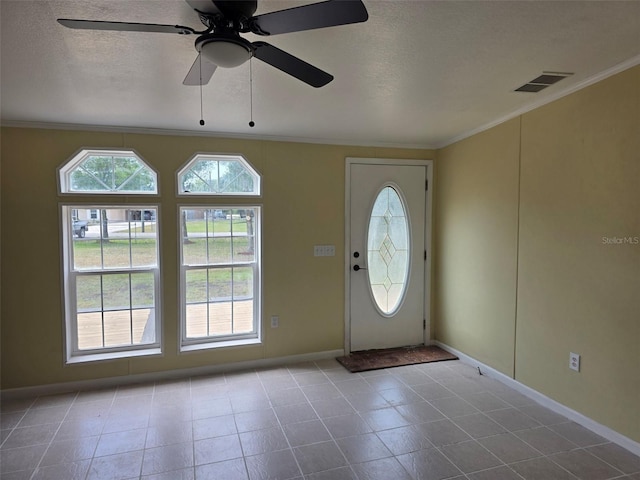 7895 NW 84th Ct, Okeechobee, FL 34972 - entrance foyer featuring a textured ceiling, visible vents, ornamental molding, and baseboards