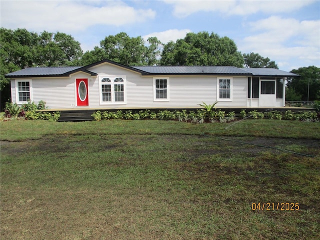 7895 NW 84th Ct, Okeechobee, FL 34972 - manufactured / mobile home featuring a sunroom, metal roof, and a front yard