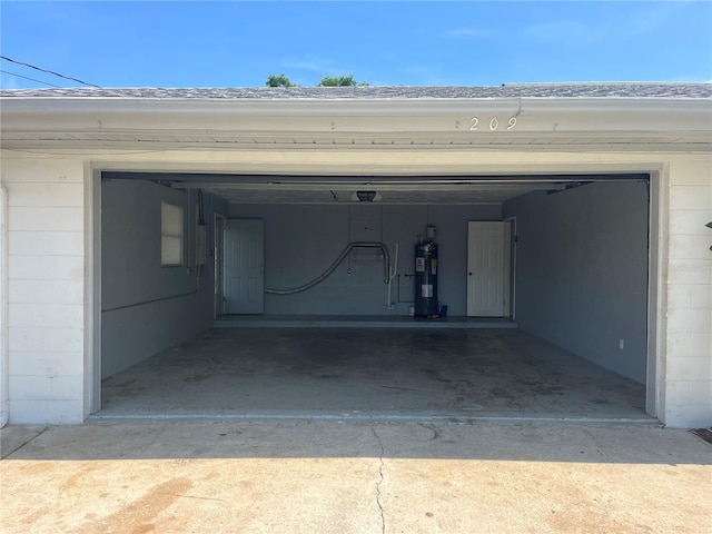 garage featuring water heater and driveway