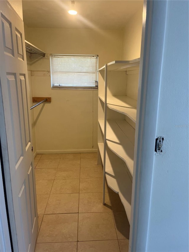 spacious closet featuring light tile patterned floors