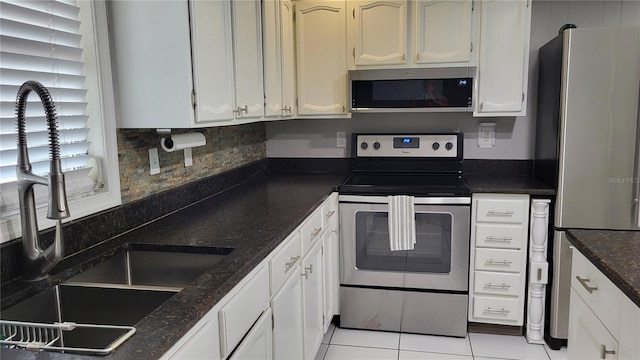 1066 5th St, Okeechobee, FL 34974 - kitchen with stainless steel appliances, a sink, and white cabinets
