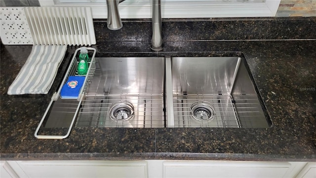 1066 5th St, Okeechobee, FL 34974 - kitchen view of a sink, white cabinetry, and dark stone countertops