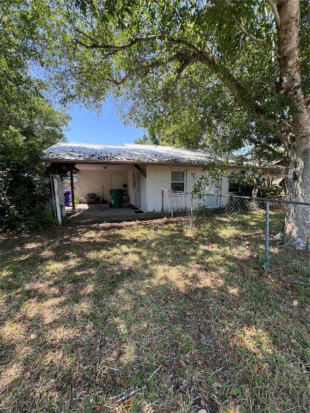 508 NW 17th St, Okeechobee, FL 34972 - back of house with stucco siding, fence, a patio, and metal roof