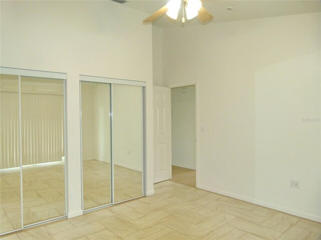 5264 Se 42nd Trace -, Okeechobee, FL 34974 - unfurnished bedroom with two closets, baseboards, and a ceiling fan