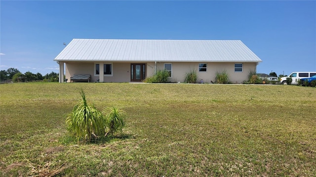 16159 NW 258th St, Okeechobee, FL 34972 - view of front of house with stucco siding, a front lawn, and metal roof
