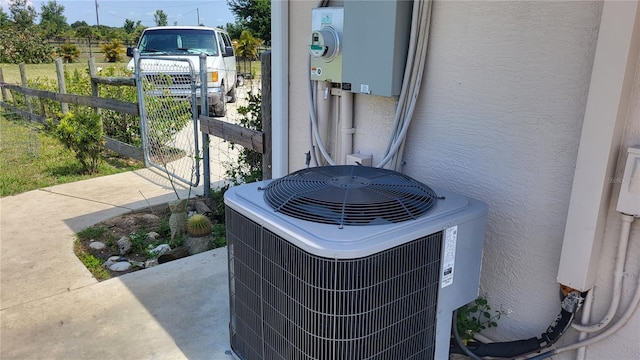 16159 NW 258th St, Okeechobee, FL 34972 - exterior view of cooling unit, a gate, stucco siding, and fence