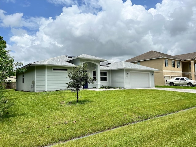 4486 SW Cacao St, Port St Lucie, FL 34953 - view of front facade featuring a garage, concrete driveway, a front yard, roof mounted solar panels, and roof with shingles