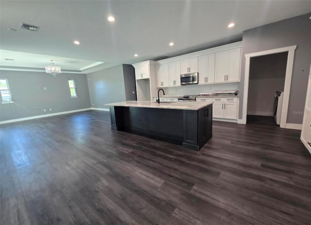 4486 SW Cacao St, Port St Lucie, FL 34953 - kitchen with appliances with stainless steel finishes, baseboards, dark wood-type flooring, white cabinetry, and recessed lighting