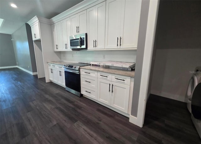 4486 SW Cacao St, Port St Lucie, FL 34953 - kitchen with appliances with stainless steel finishes, dark wood-style floors, baseboards, white cabinetry, and recessed lighting