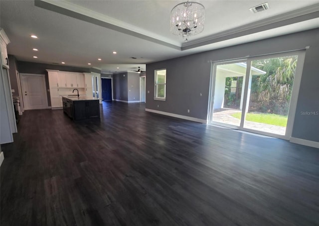 4486 SW Cacao St, Port St Lucie, FL 34953 - unfurnished living room featuring a chandelier, baseboards, dark wood-type flooring, recessed lighting, and a sink