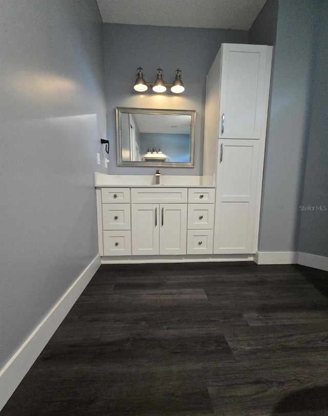 4486 SW Cacao St, Port St Lucie, FL 34953 - bathroom with baseboards, wood finished floors, and vanity