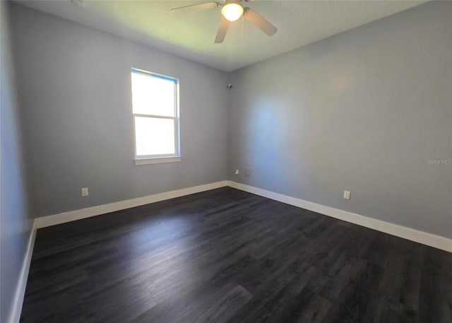4486 SW Cacao St, Port St Lucie, FL 34953 - empty room featuring a ceiling fan, dark wood finished floors, and baseboards