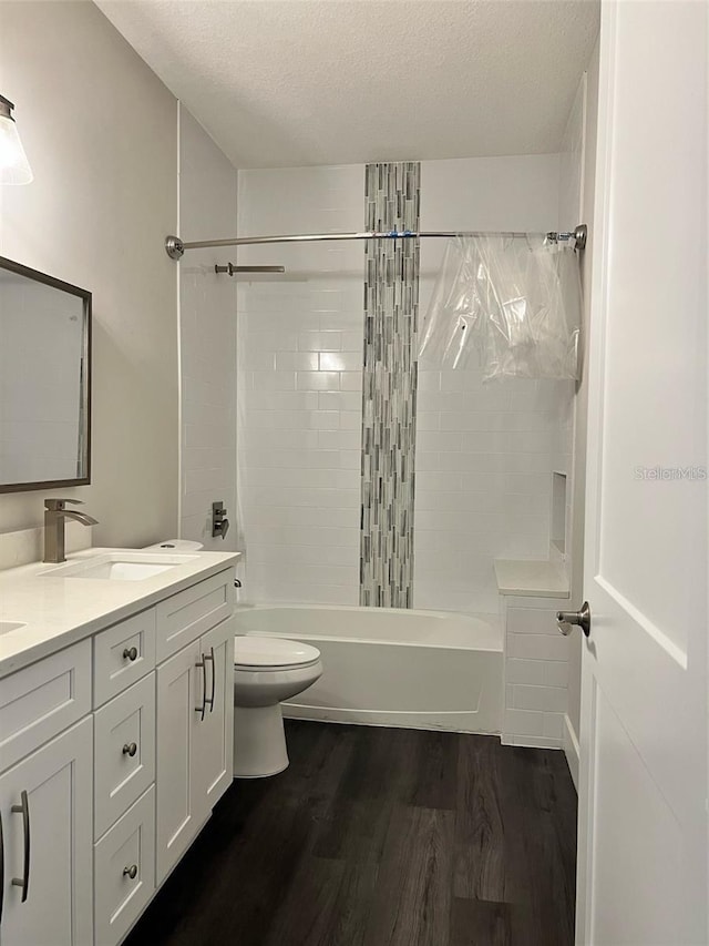4486 SW Cacao St, Port St Lucie, FL 34953 - full bath with wood finished floors, toilet, bathing tub / shower combination, a textured ceiling, and double vanity