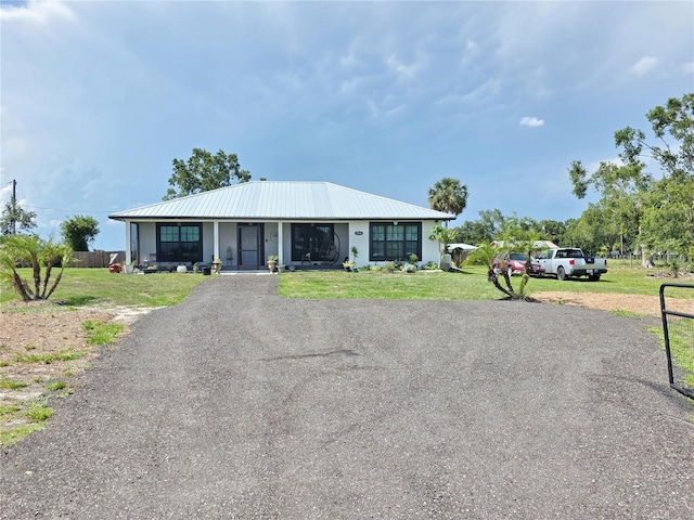 7935 NW 90th Ct, Okeechobee, FL 34972 - view of front of house with metal roof and a front lawn