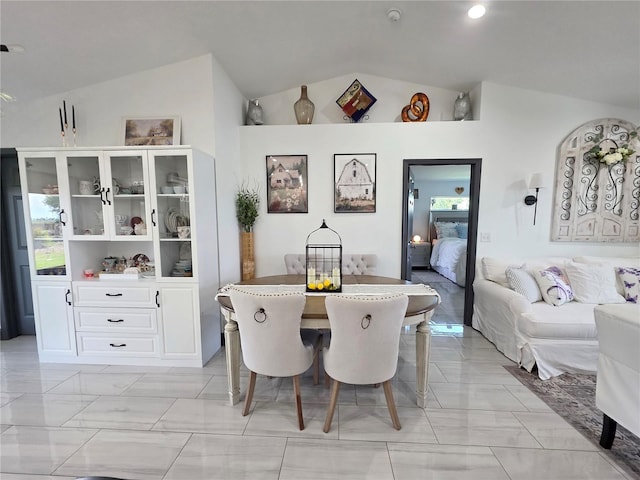 7935 NW 90th Ct, Okeechobee, FL 34972 - dining space with lofted ceiling and light marble finish floors