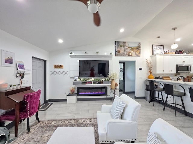 7935 NW 90th Ct, Okeechobee, FL 34972 - living room featuring vaulted ceiling, ceiling fan, a glass covered fireplace, baseboards, and recessed lighting