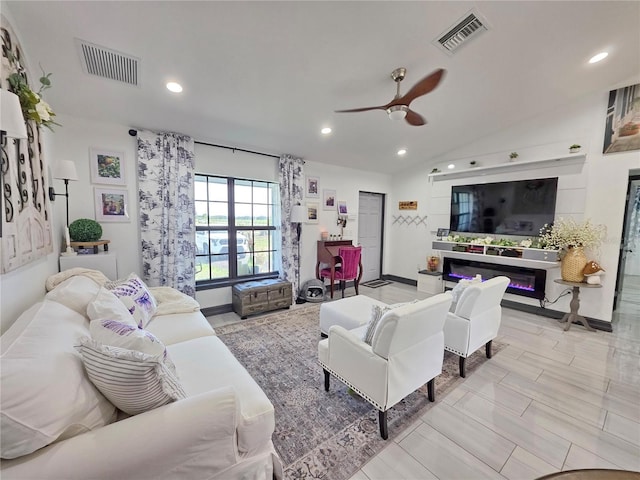 7935 NW 90th Ct, Okeechobee, FL 34972 - living room with a glass covered fireplace, a ceiling fan, recessed lighting, and lofted ceiling
