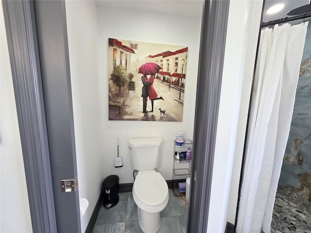7935 NW 90th Ct, Okeechobee, FL 34972 - full bath with toilet, tile patterned flooring, a shower with shower curtain, and baseboards