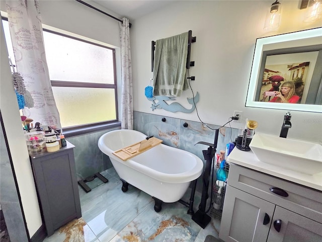 7935 NW 90th Ct, Okeechobee, FL 34972 - bathroom with vanity, a freestanding tub, and tile walls