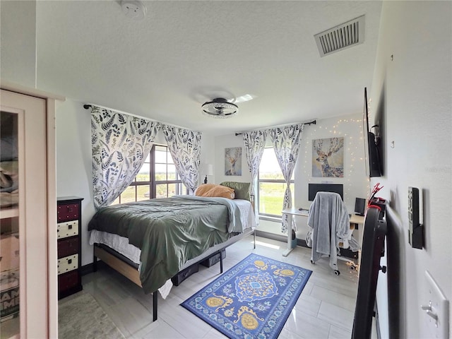 7935 NW 90th Ct, Okeechobee, FL 34972 - bedroom with multiple windows and a textured ceiling