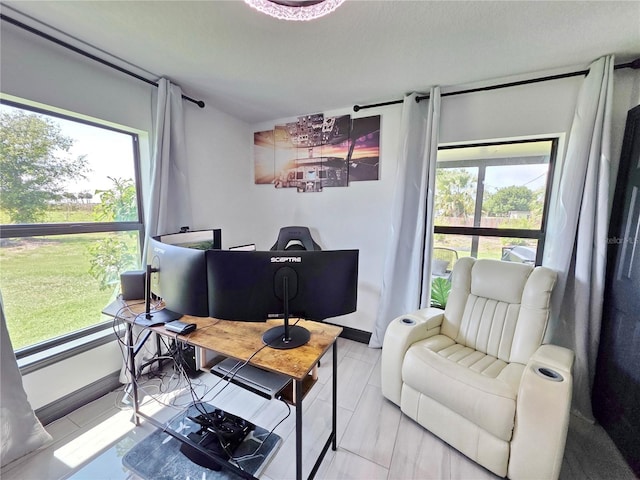 7935 NW 90th Ct, Okeechobee, FL 34972 - living area with plenty of natural light, a desk, and baseboards