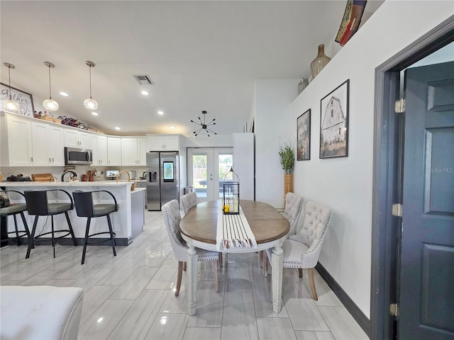 7935 NW 90th Ct, Okeechobee, FL 34972 - dining room with french doors, vaulted ceiling, and recessed lighting