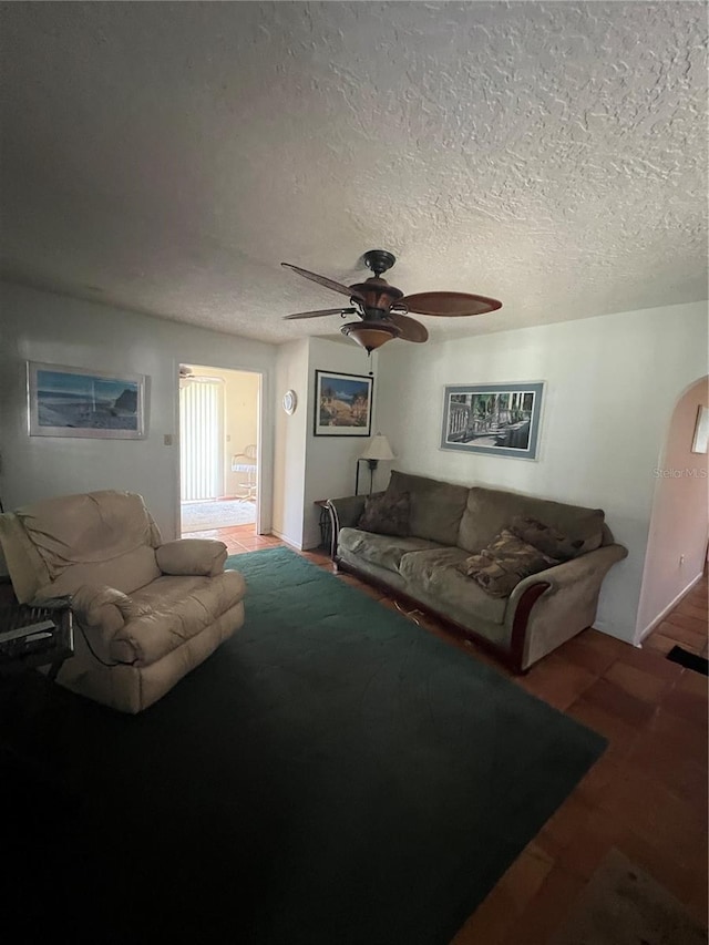 1096 8th St, Okeechobee, FL 34974 - living room featuring ceiling fan, wood finished floors, a textured ceiling, and arched walkways