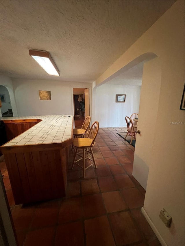 1096 8th St, Okeechobee, FL 34974 - bar with arched walkways and a textured ceiling