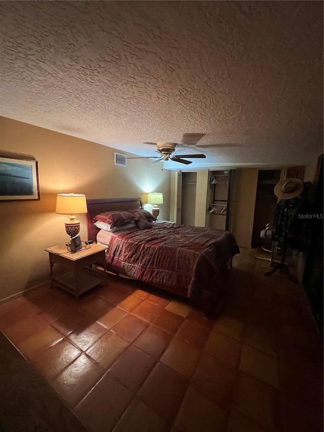 1096 8th St, Okeechobee, FL 34974 - bedroom featuring a textured ceiling, a ceiling fan, and tile patterned flooring