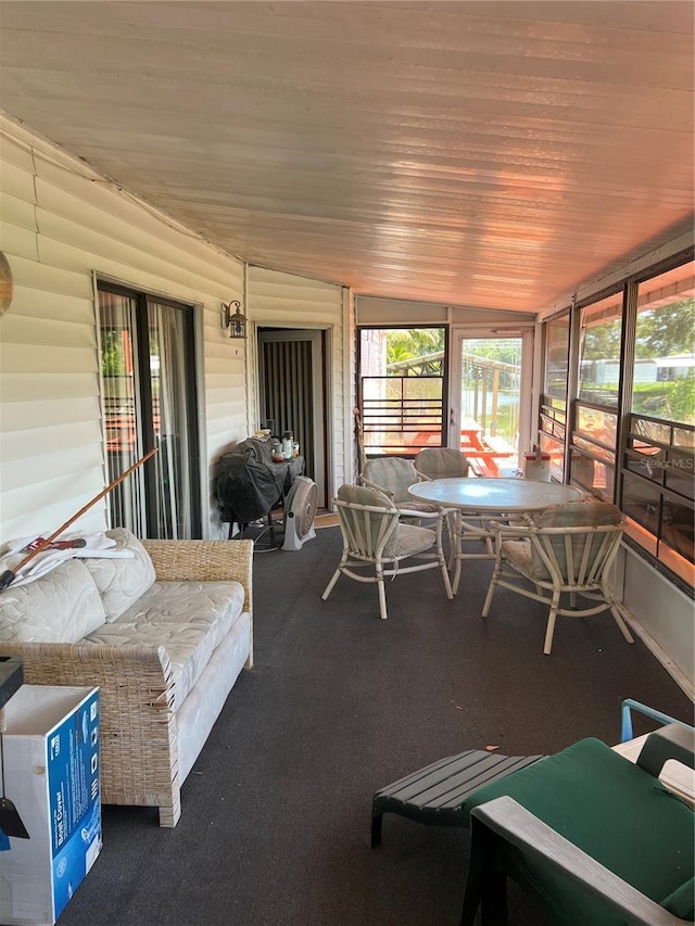 1096 8th St, Okeechobee, FL 34974 - sunroom / solarium featuring healthy amount of natural light, wood ceiling, and carpet floors