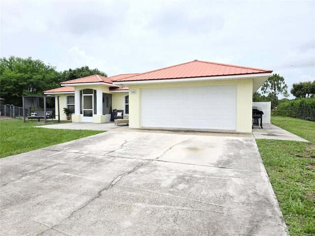 3897 NW 22nd Ave, Okeechobee, FL 34972 - view of front of property featuring stucco siding, concrete driveway, metal roof, and a front yard