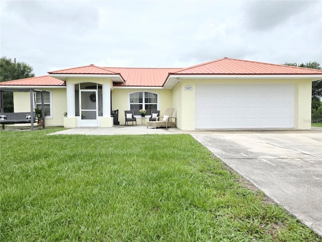 3897 NW 22nd Ave, Okeechobee, FL 34972 - ranch-style house featuring stucco siding, metal roof, driveway, and an attached garage