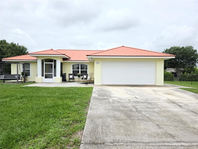 3897 NW 22nd Ave, Okeechobee, FL 34972 - ranch-style home with stucco siding, driveway, a front lawn, metal roof, and an attached garage