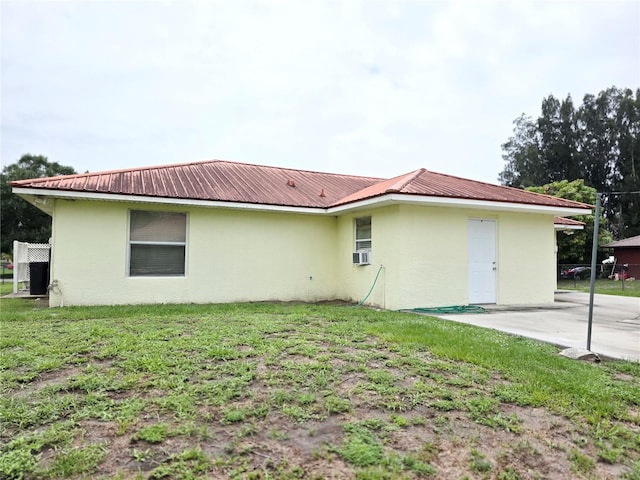 3897 NW 22nd Ave, Okeechobee, FL 34972 - rear view of house featuring stucco siding, metal roof, a yard, and a patio