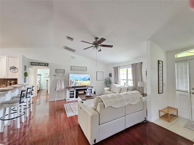 3897 NW 22nd Ave, Okeechobee, FL 34972 - living area with vaulted ceiling, ceiling fan, wood finished floors, and baseboards