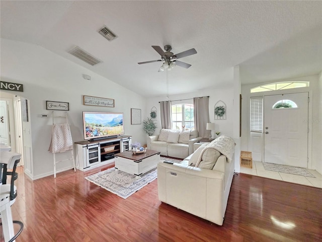 3897 NW 22nd Ave, Okeechobee, FL 34972 - living area featuring vaulted ceiling, wood finished floors, a ceiling fan, and baseboards