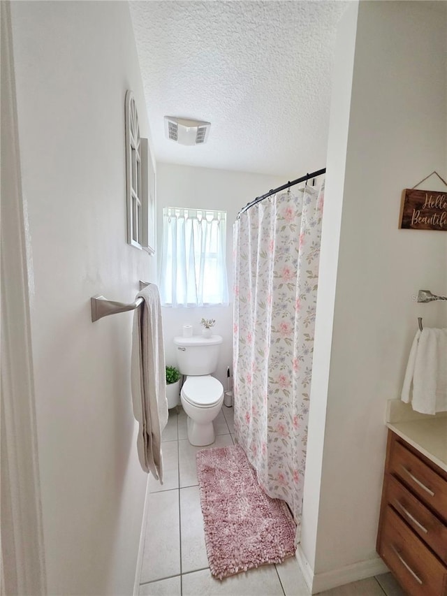 3897 NW 22nd Ave, Okeechobee, FL 34972 - bathroom featuring toilet, tile patterned flooring, a textured ceiling, a shower with shower curtain, and vanity