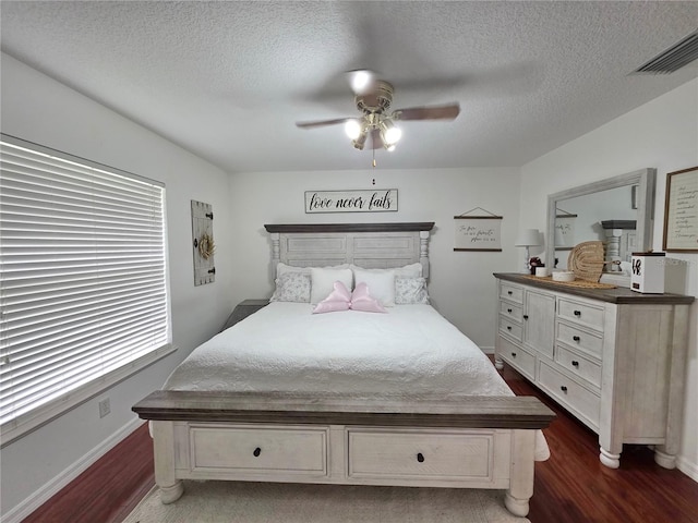 3897 NW 22nd Ave, Okeechobee, FL 34972 - bedroom featuring dark wood-style flooring, a textured ceiling, baseboards, and ceiling fan