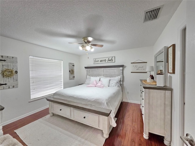 3897 NW 22nd Ave, Okeechobee, FL 34972 - bedroom featuring dark wood finished floors, baseboards, ceiling fan, and a textured ceiling