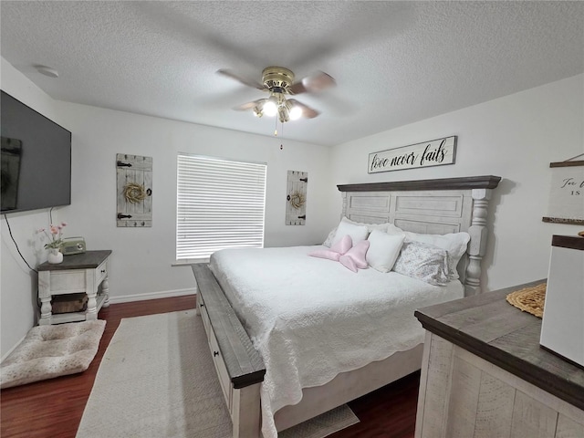 3897 NW 22nd Ave, Okeechobee, FL 34972 - bedroom featuring dark wood-style flooring, a textured ceiling, baseboards, and a ceiling fan
