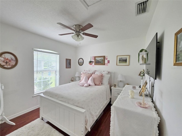 3897 NW 22nd Ave, Okeechobee, FL 34972 - bedroom featuring dark wood finished floors, baseboards, ceiling fan, and a textured ceiling